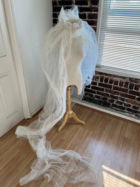 1980's Silk Braided Veil with XXXL Train on a manakin with the train length displayed on the floor.